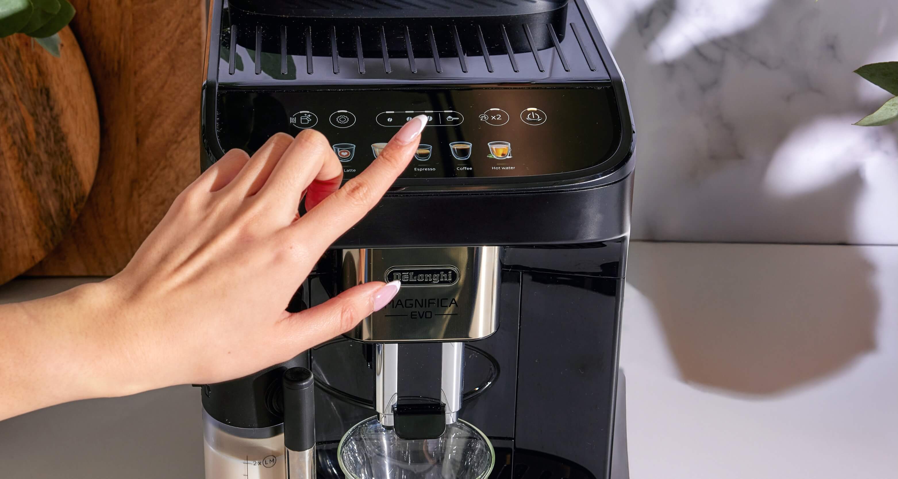 pressing button on coffee machine